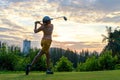 Golfer sport course golf ball fairway.ÃÂ  People lifestyle woman playing game golf tee of on the green grass sunset background. Royalty Free Stock Photo